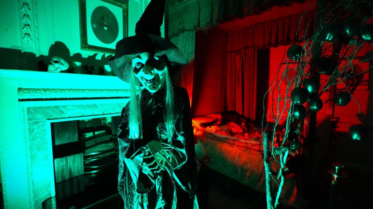 A large witch mannequin in a spookily decorated room at Ormesby Hall